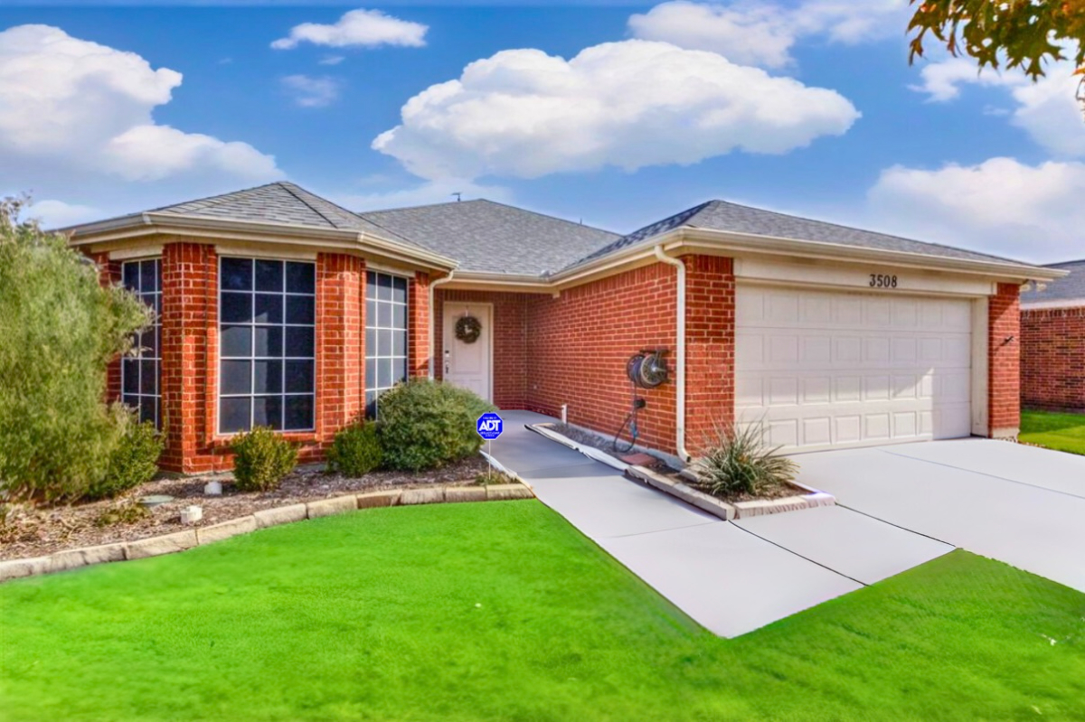 Angled front view of the brick home and driveway