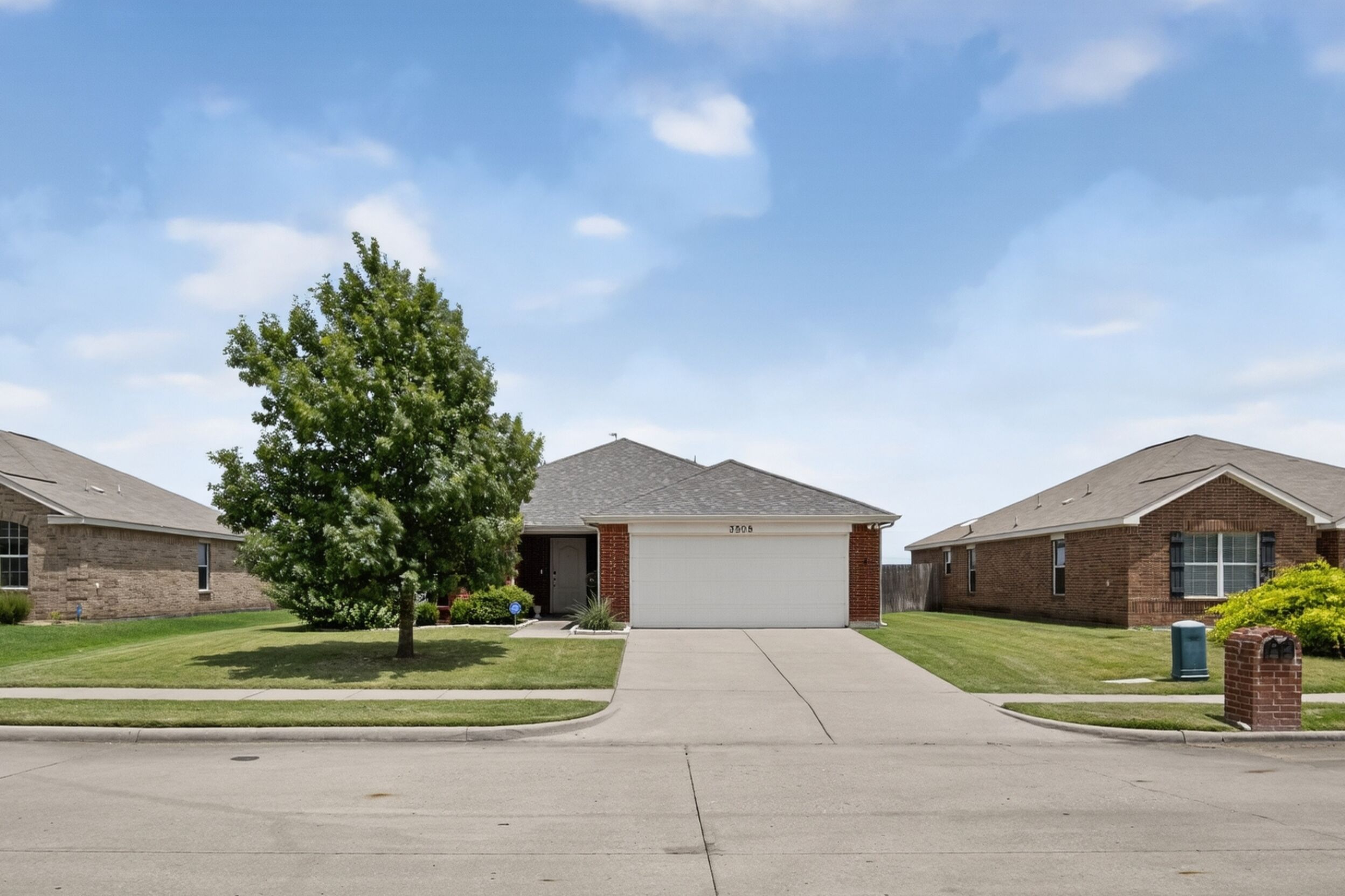 Front of the home with driveway and mailbox