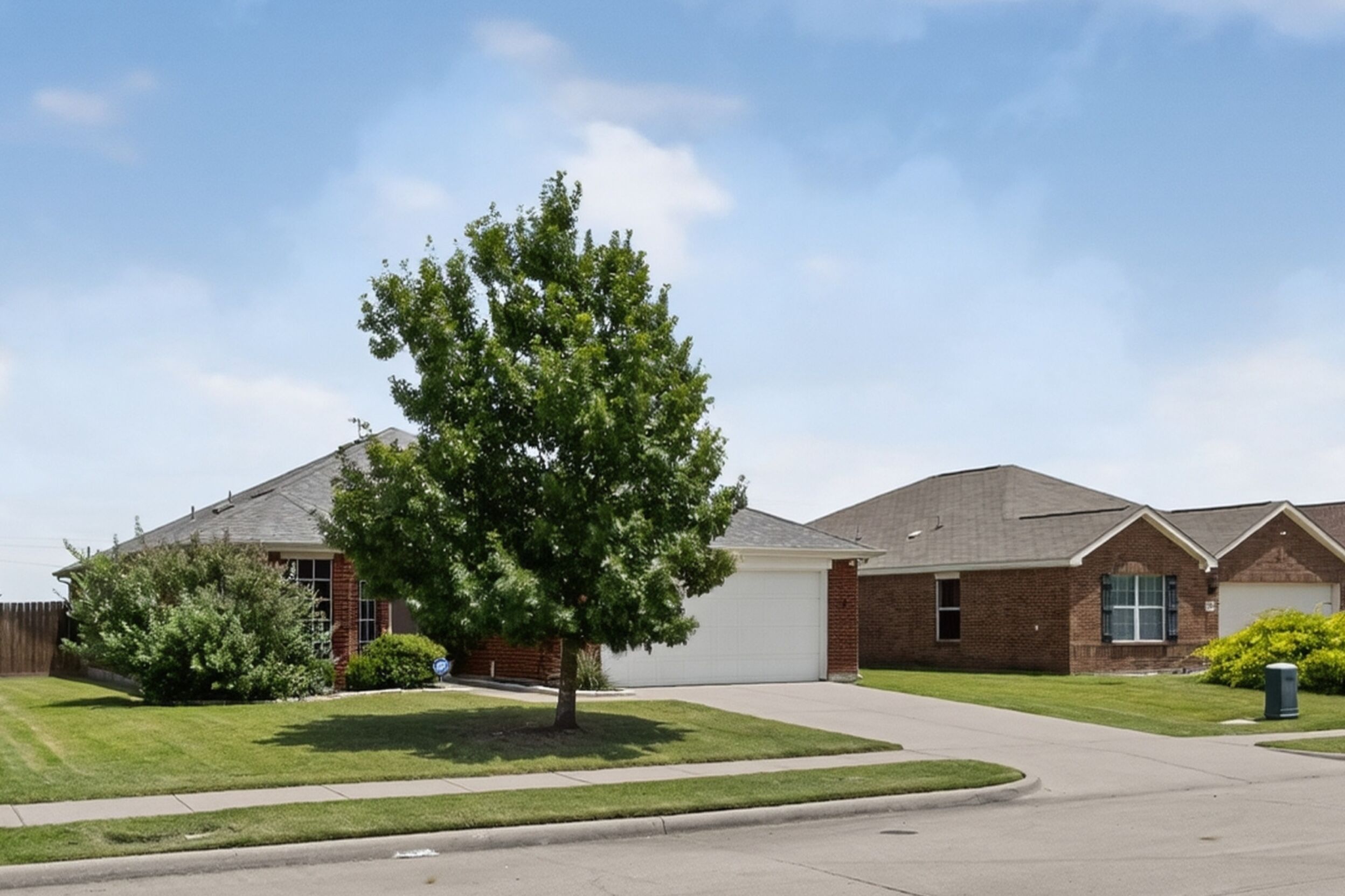 Front exterior with a mature shade tree