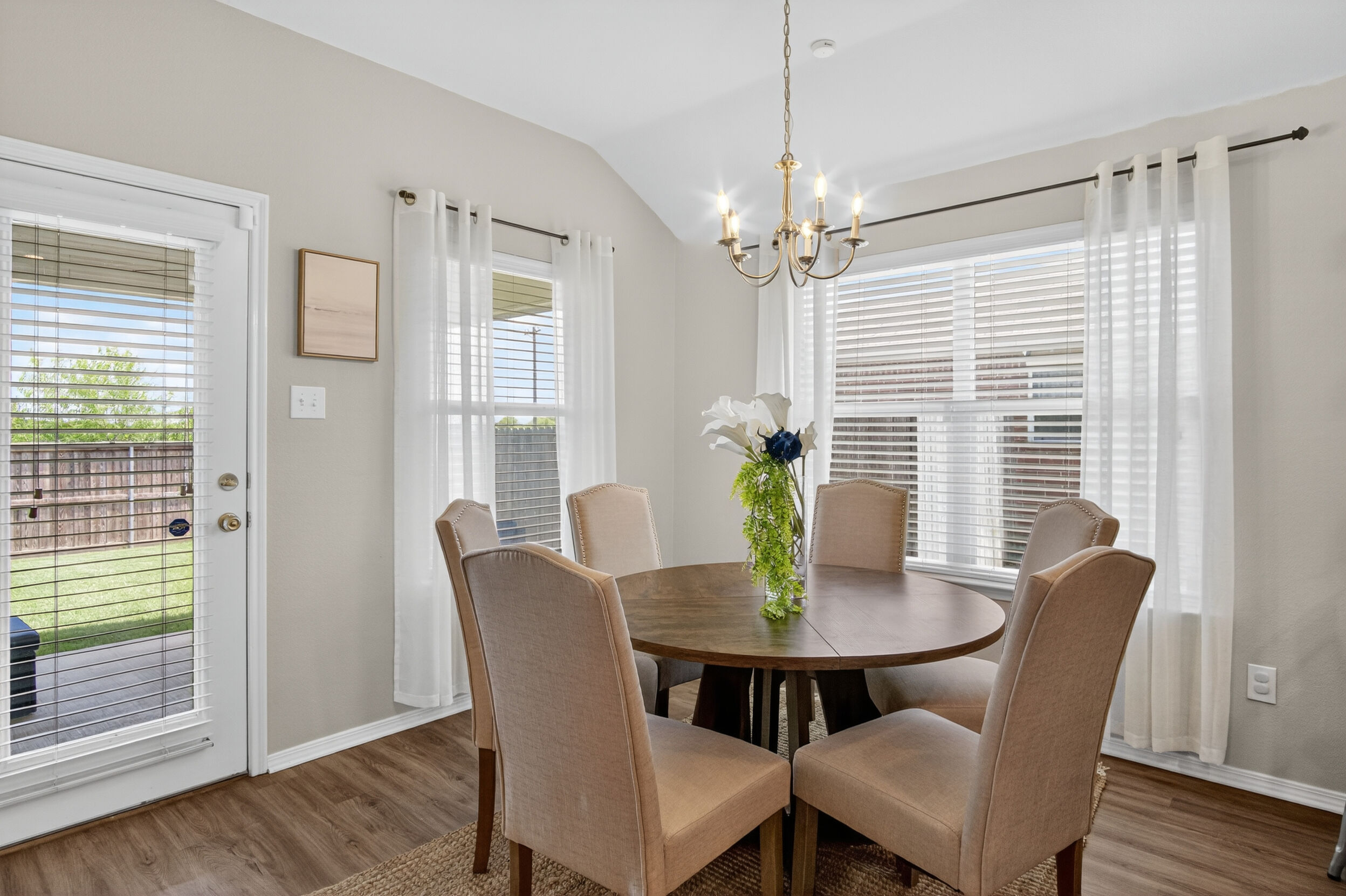 Dining nook with round table and coastal art