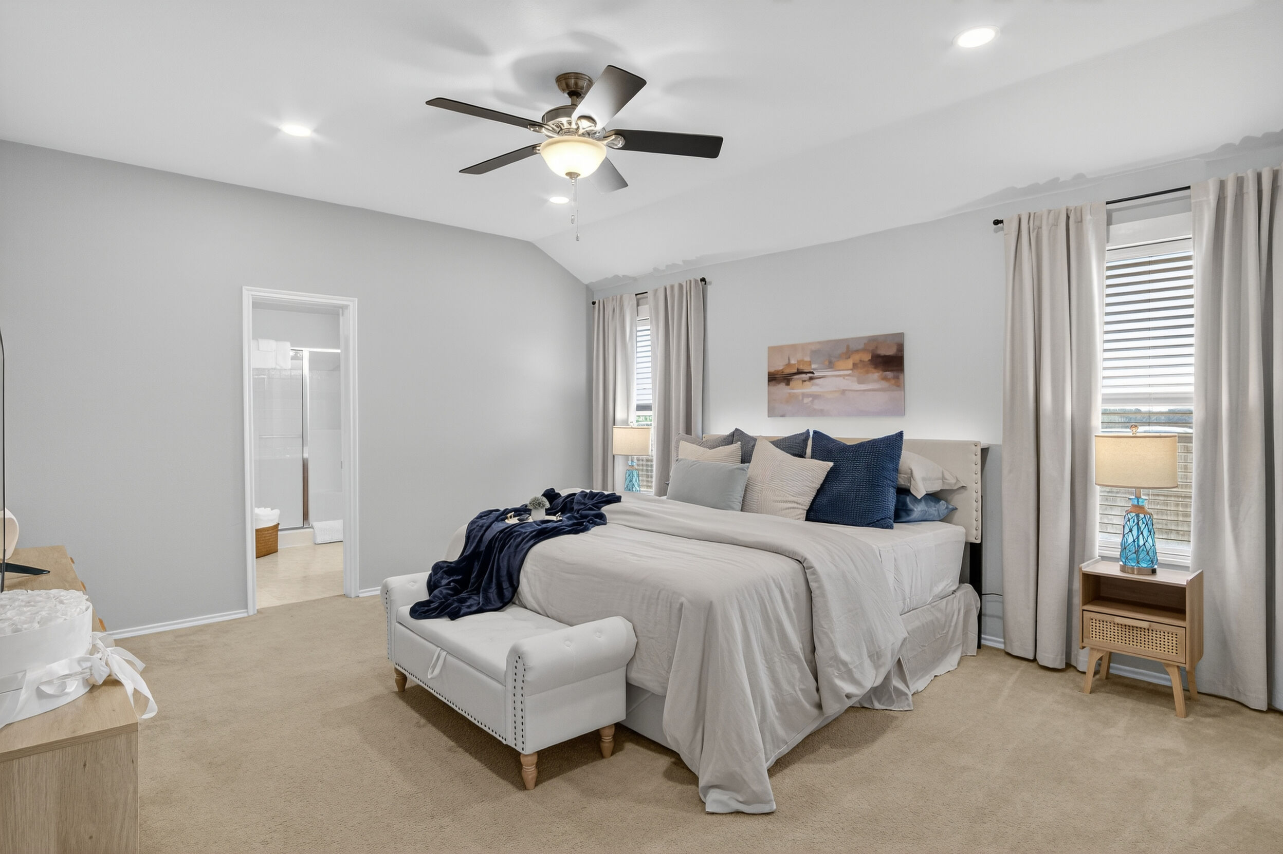 Primary bedroom with queen bed and ceiling fan