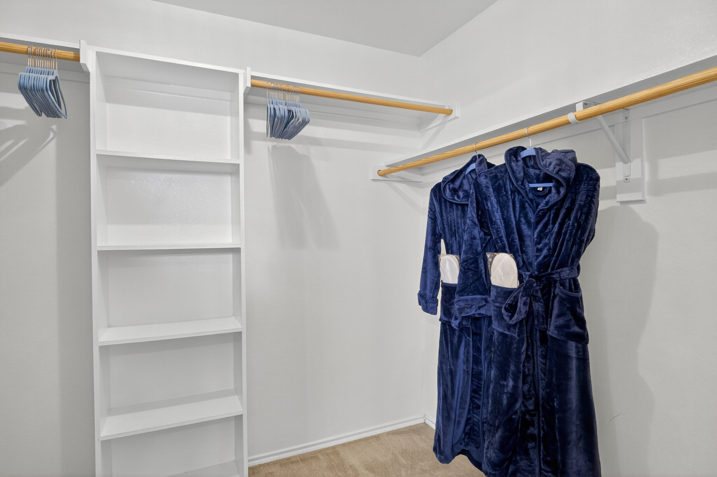 Walk-in closet with plush navy robes