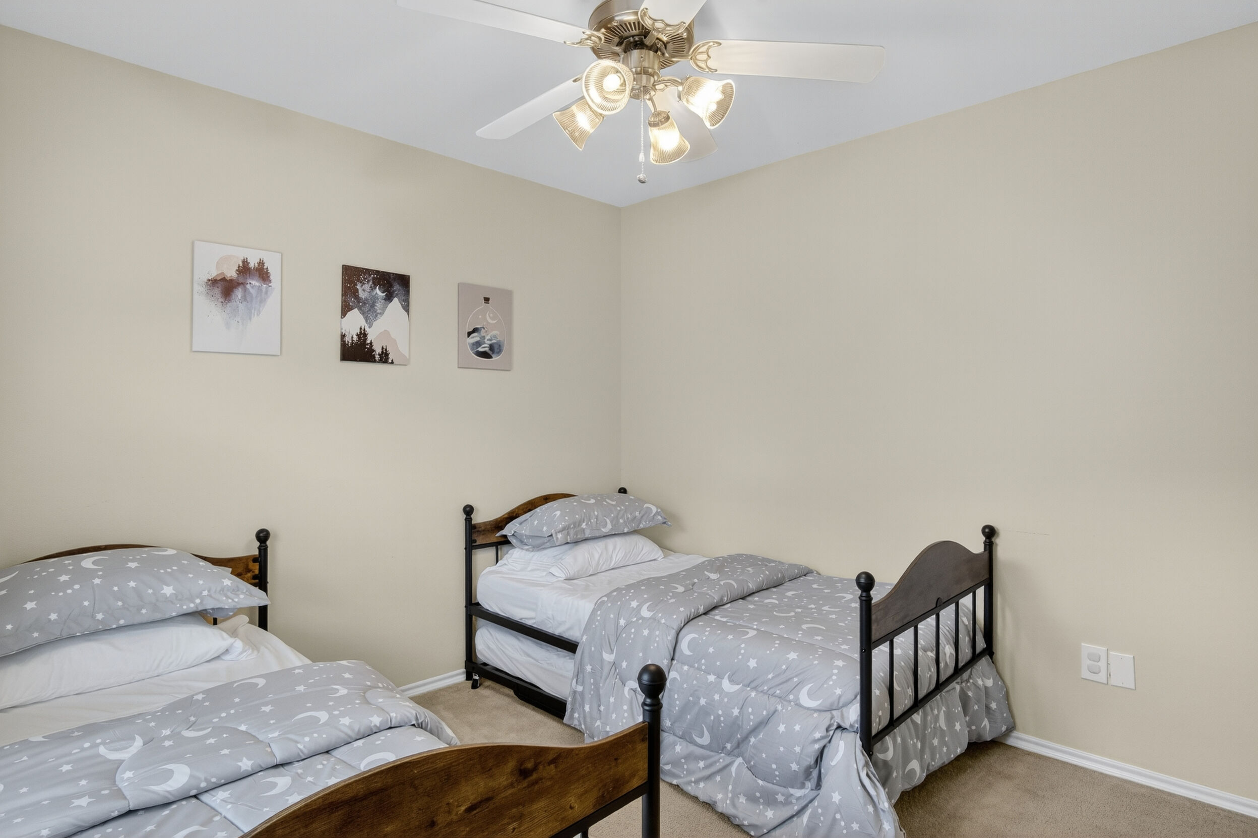 Bedroom with two twin beds and wall art