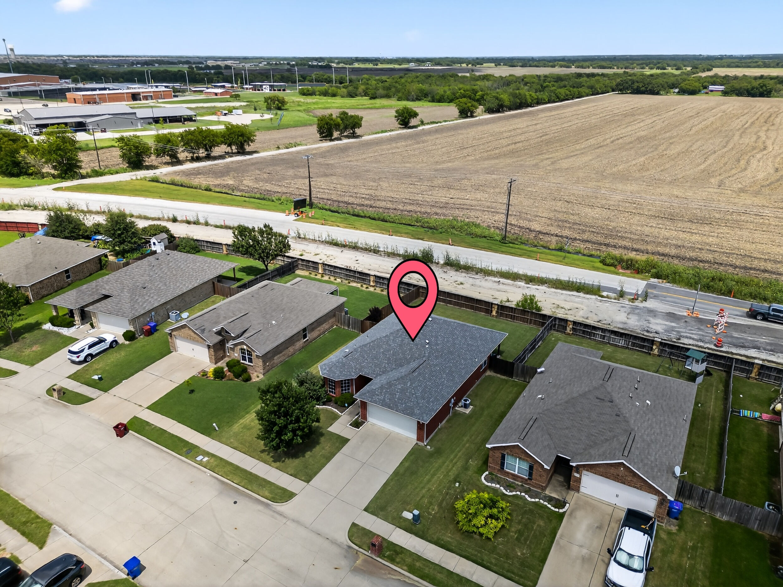 Aerial view of the home within the neighborhood
