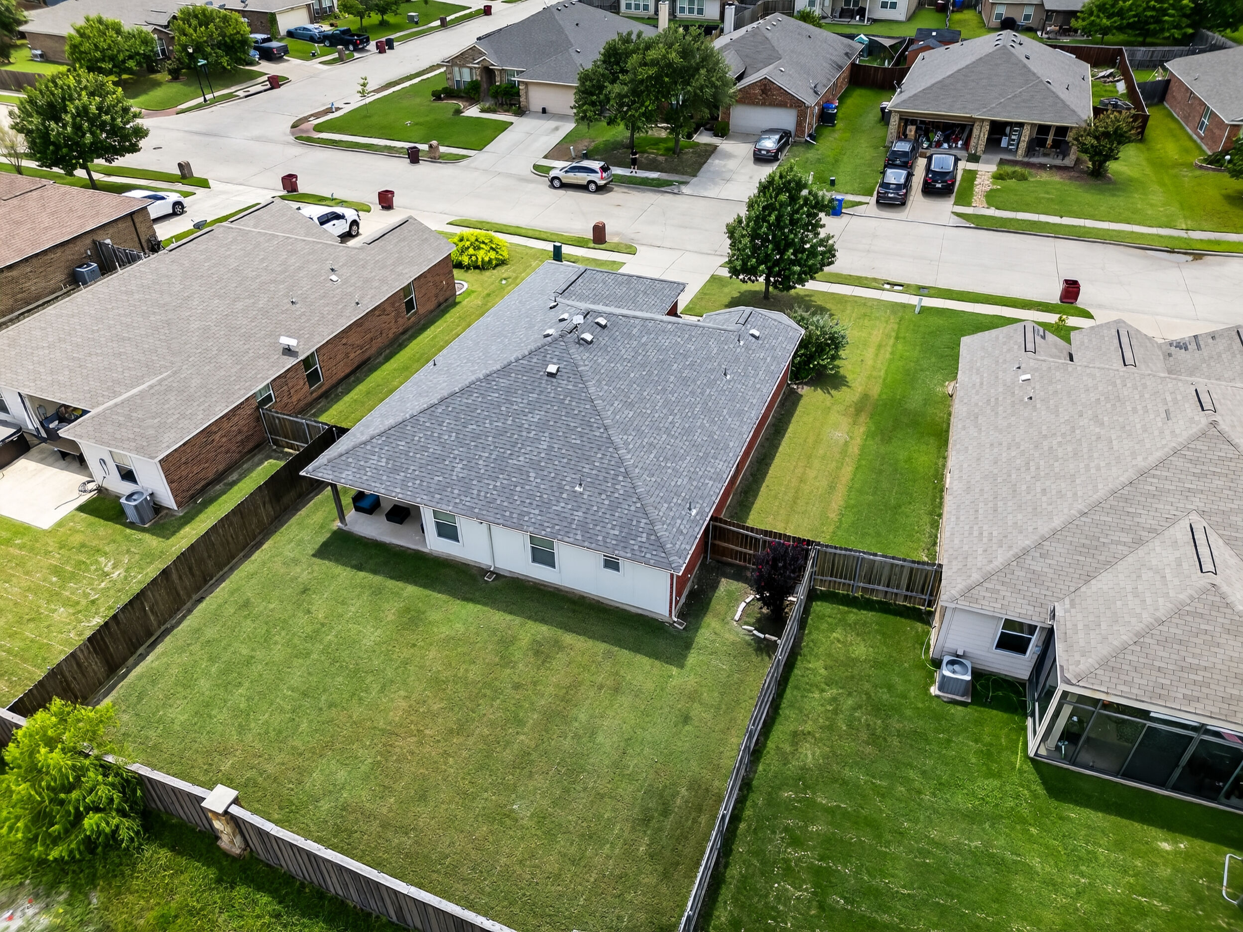 Aerial of the home and fenced backyard