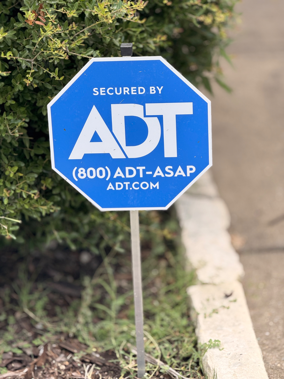 ADT security sign in the front landscaping