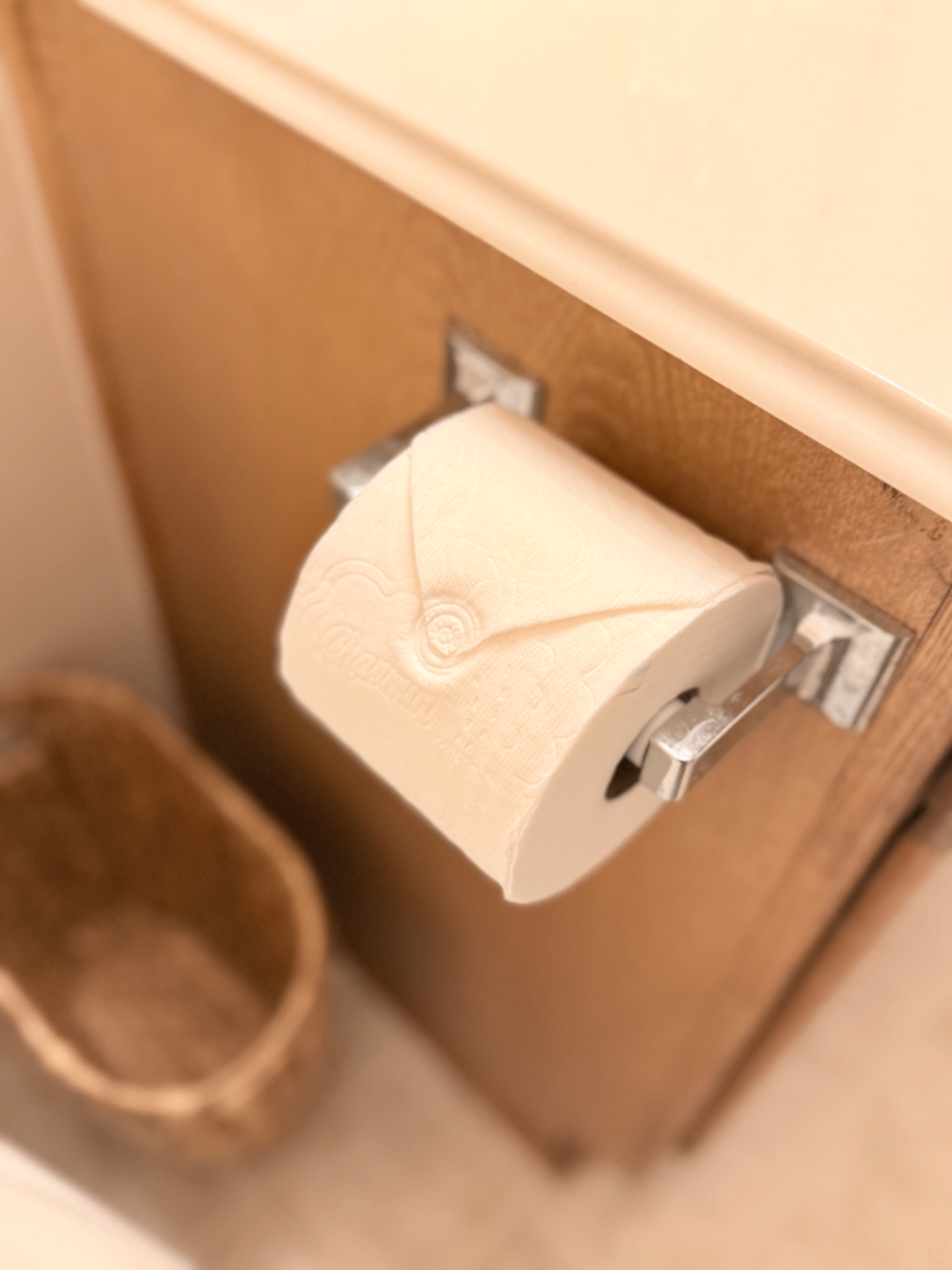 Bathroom with toilet paper holder and woven basket