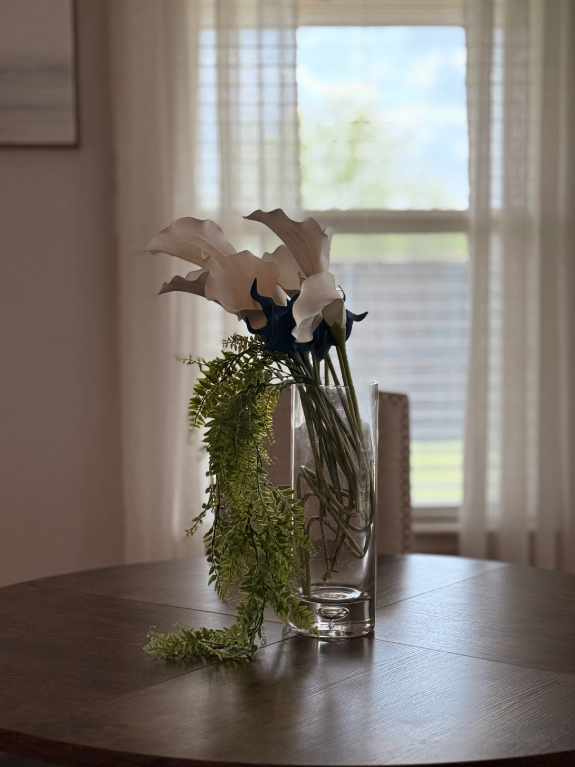 Fresh floral arrangement on the dining table by the window