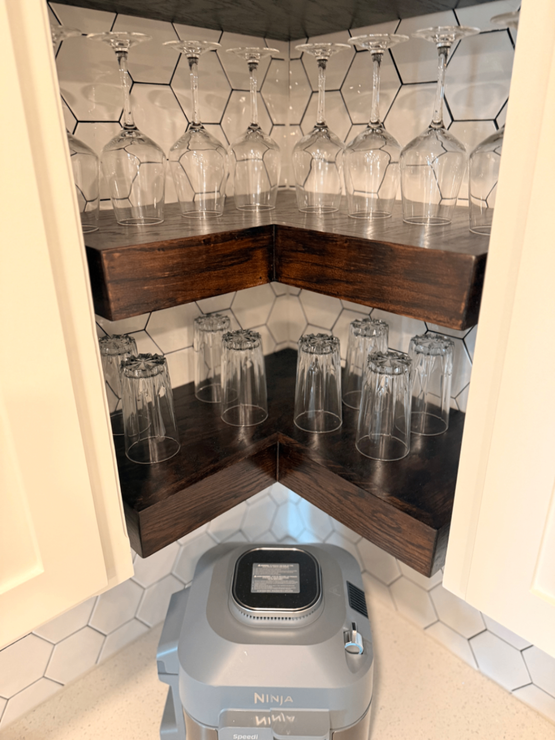 Wine and drinking glasses on floating corner shelves