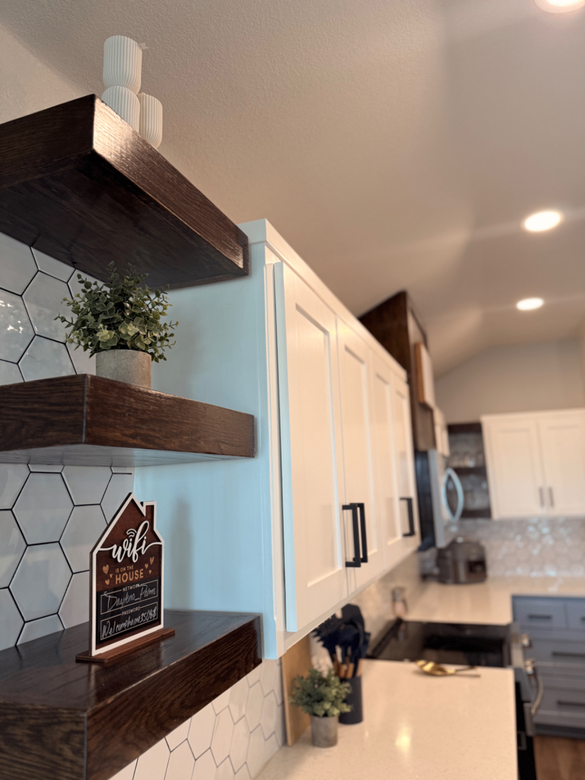 Floating wood shelves with greenery and wifi sign in the kitchen